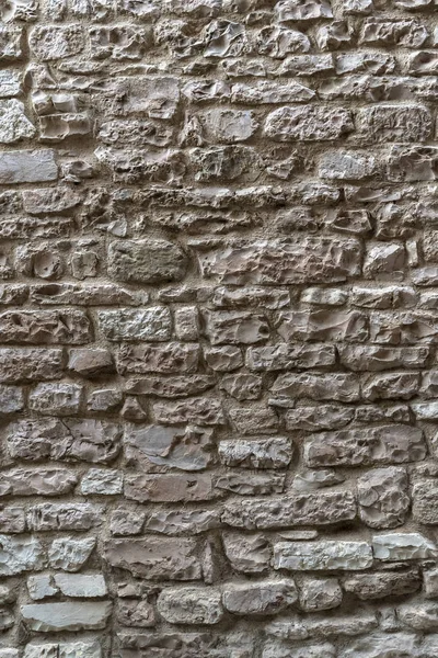 Rustic wall made of irregular stones blocks