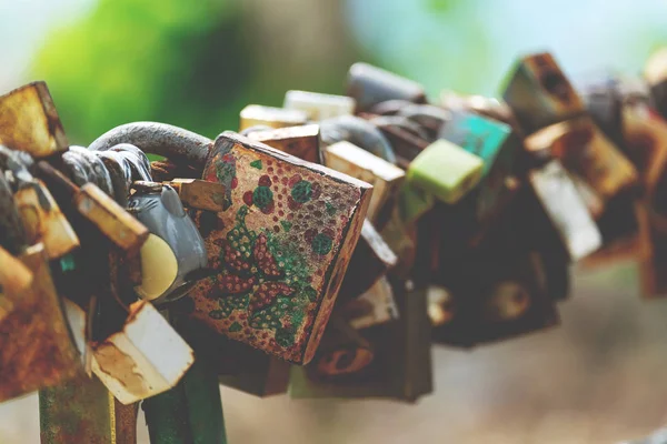 Symbolic of Love padlocks on the Rail of the Bridge, Old and Rusty Padlocks hanging for Long Time.