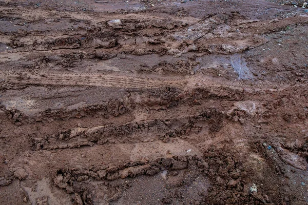 Vehicles Tire Tracks on Mud in the Forrest. Wheel Tracks on the Wet Soil.