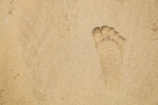 Footprint on the Beach Sand. Human Barefoot Mark After Walk.