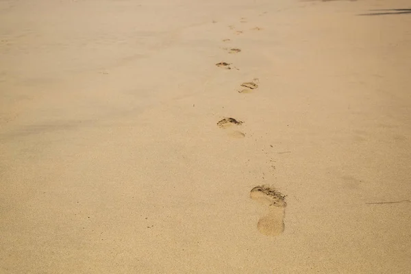 Footprint on the Beach Sand. Human Barefoot Mark After Walk.