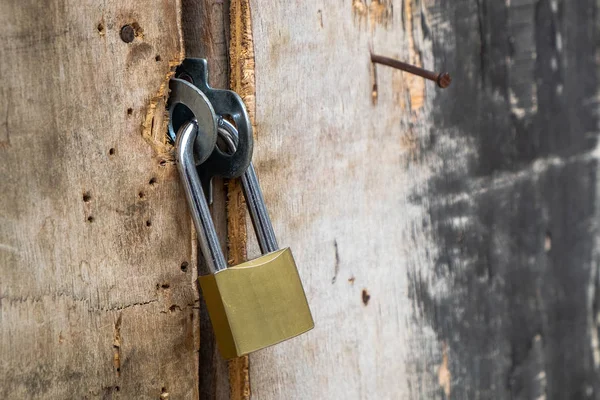 Hög säkerhet låst på en gammal plywood dörr av mässing hänglås. — Stockfoto