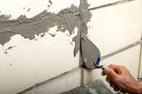 Umiejętne staruszek tynkowania cement cementowy na starej cegły — Zdjęcie stockowe