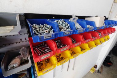 Various Screws and Nuts on the Simple Shelves in the Garage for DIY Fixing. clipart
