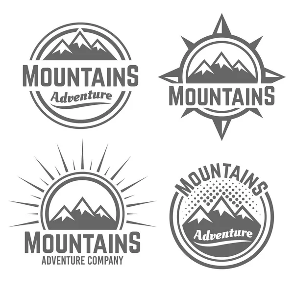 Montañas vector cuatro emblemas vintage monocromo — Vector de stock