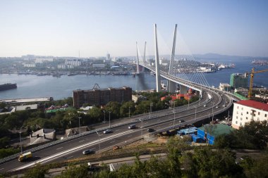 Altın Askılı köprü yol araç trafiği yukarıdan. Modern Vladivostok Rusya gece aydınlatma. Eski ve modern Merkez binaları.