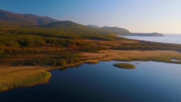 여름과 산으로 둘러싸인 아름다운 블라고다노에 Blagodatnoe 호수를 배경으로 비행합니다 러시아의 — 비디오