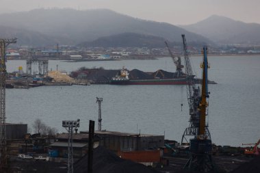 Kasım, 2014 - Nakhodka, Rusya - Nakhodka deniz kenti deniz ticaret limanında kömür terminali. Büyük bir şehrin kıyısında kömür çöküşü.