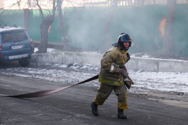 Kış, 2014 - Vladivostok, Rusya - İtfaiye ekipleri yol boyunca depolarda güçlü bir yangın söndürmek.