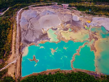 View from above. Blue waters of the former tailing dump in the village of Kavalerovo. Khrustalnensky ore mining and processing plant clipart