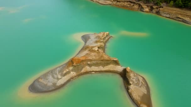 Utsikt uppifrån. Flyger över en sandö mitt i en kemisk sjö. Lagringsanläggning för svansar vid Chrusustalnenskij gruv- och bearbetningsanläggning — Stockvideo