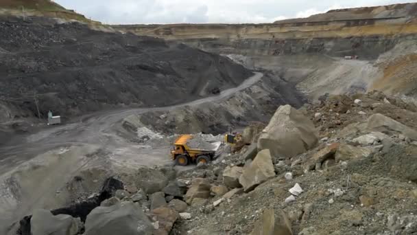 Lato, 2020 - Rosja - Otwarty dół dla górnictwa węgla. Koparka ładuje glebę do wywrotki w kopalni węgla — Wideo stockowe