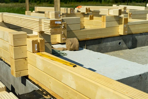Construction of a wooden house made of profiled laminated veneer lumber.