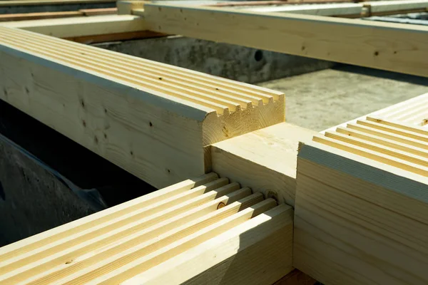 Construction of a wooden house made of profiled laminated veneer lumber.