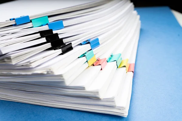 Mock up, stack of papers documents in archives files with paper clips on desk at offices, business concept. Copy space.