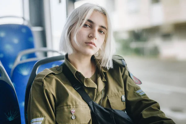 Young blonde woman with short haircut in urban transportation