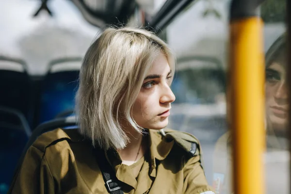 Young blonde woman with short haircut in urban transportation