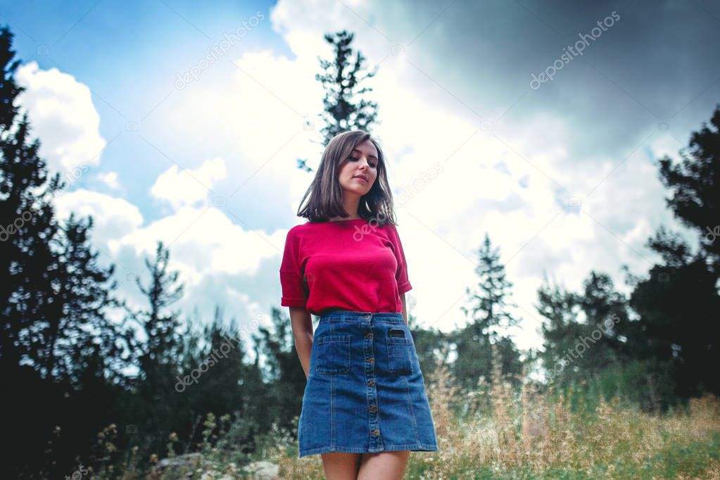 young girl posing in summer forest