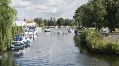 BECCLES, SUFFOLK, UK, JULY 2018 - Boats on the river Waveney in the old market town of Beccles, Suffolk, UK clipart