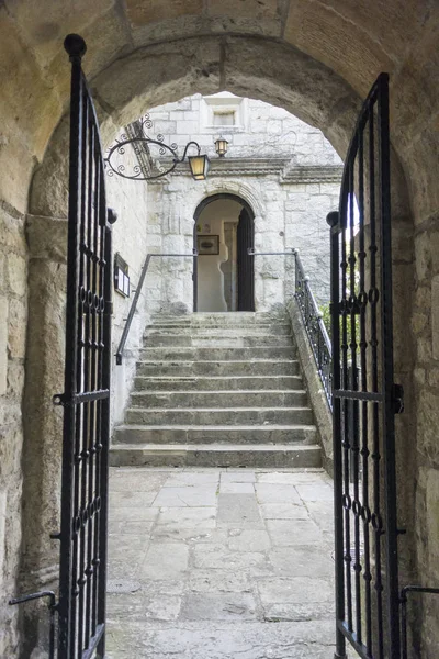 Ancient stone arch and gateway leading through to steps