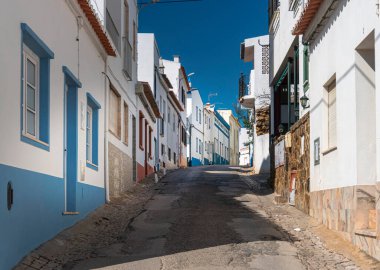 Narrow street in the Fishing village of Burgau in the Algarve, Portugal clipart