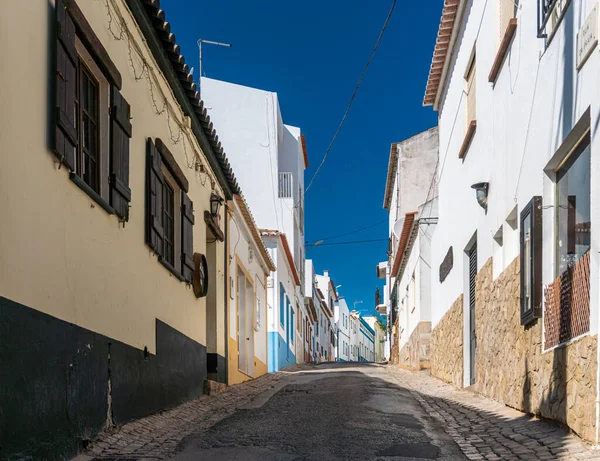 Narrow street in the Fishing village of Burgau in the Algarve, Portugal