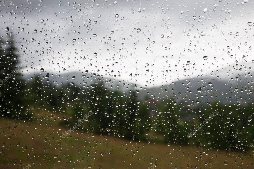 Raindrops on the window. Rainy weather. Rain in the Carpathians