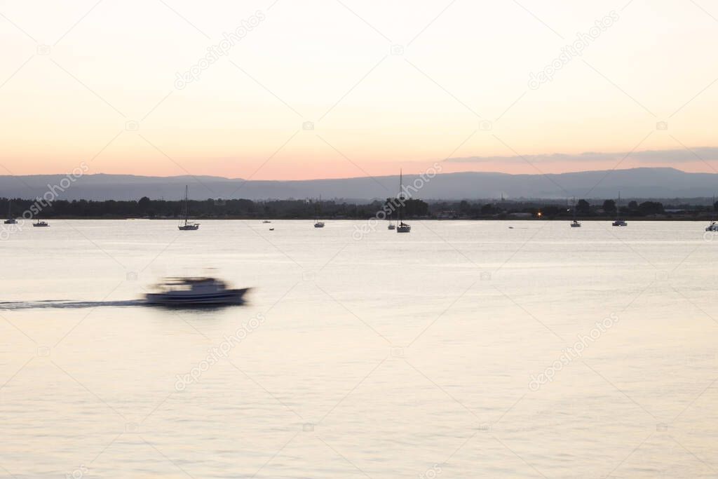 Boats at sunset, Syracuse, Sicily, Italy. At sunset, at sunrise