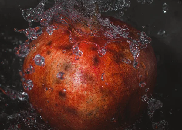 Fruta de granada fresca con agua salpicada — Foto de Stock