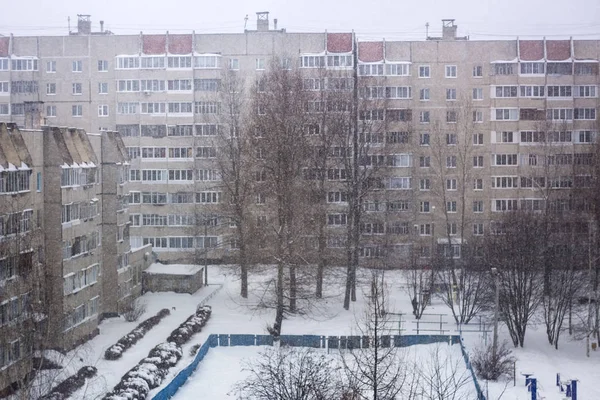 Heavy snowfall in the city. Streets, trees and snow. the view from the top