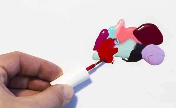 a person draws an abstract picture of the nail Polish