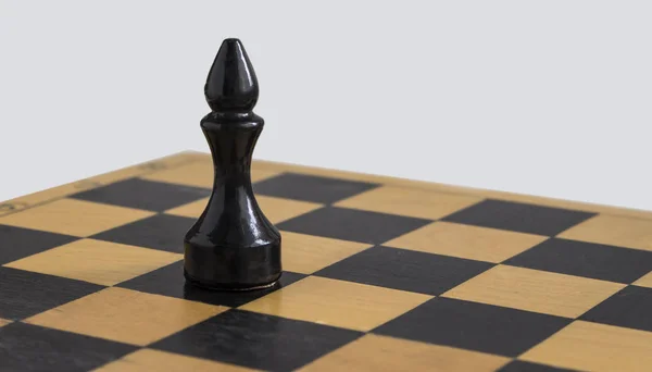 wooden black chess Bishop on a chess Board