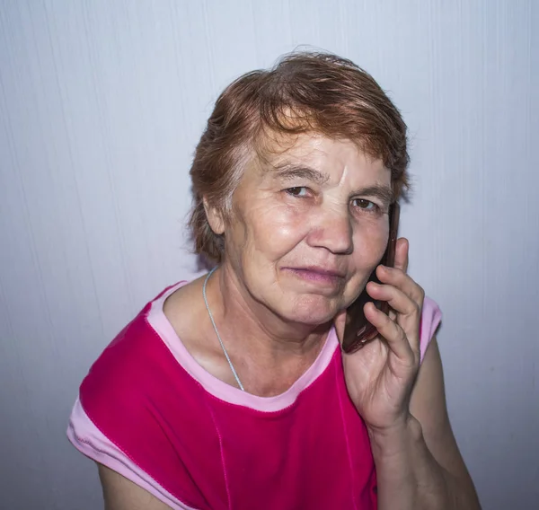 Elderly Woman Sits Holds Phone Her Ear — Stock Photo, Image