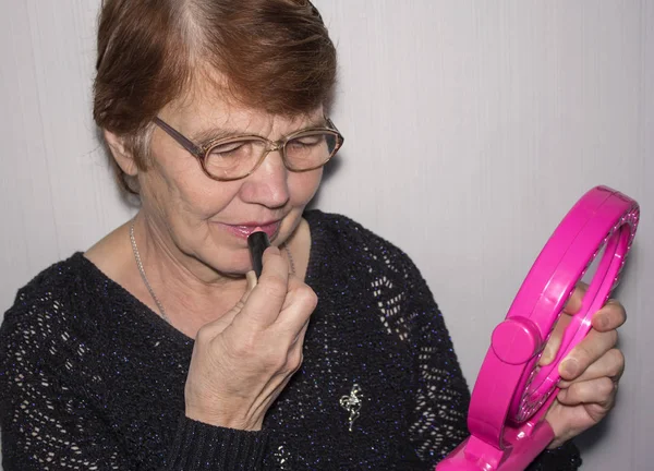 Elderly Woman Glasses Paints Her Lips Lipstick Looking Mirror — Stock Photo, Image