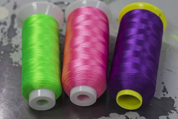colored thread for machine embroidery, acid colors, lie on the surface