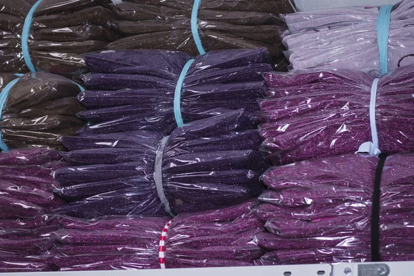 Different sizes of clothing in the store on the shelves in the package — Stock Photo, Image