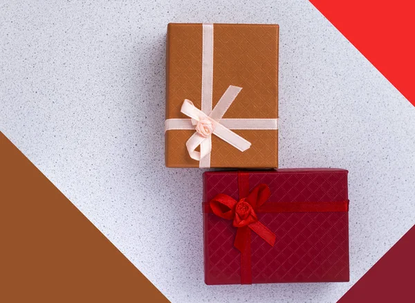 Dos cajas de regalo en rojo y naranja, con arcos — Foto de Stock