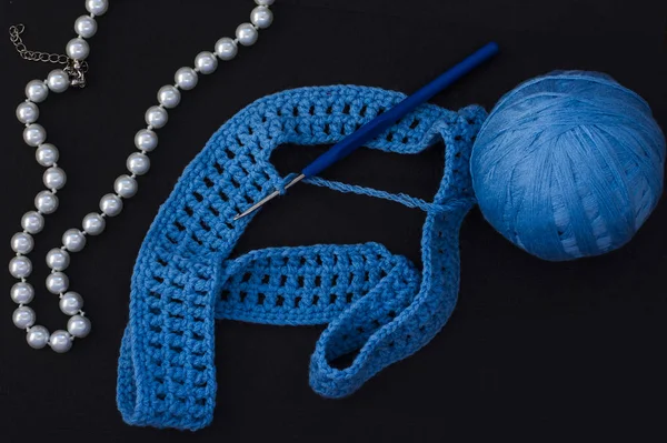 Skein of blue thread with crochet and knitting on black background with pearl beads for women — Stock Photo, Image