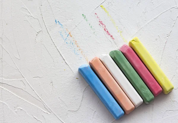 Crayons de couleur doublés en ligne sur un fond texturé blanc avec une copie de l'espace — Photo