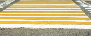 Sarı beyaz yaya geçidi şehir yolunda.