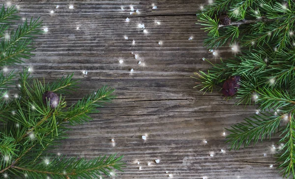 冬の休日の概念、木製の背景に氷の結晶と雪片とモミの枝のフレーム — ストック写真