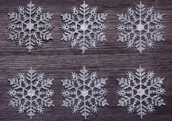 Conceito de férias de inverno, fundo de seis flocos de neve em uma superfície de madeira — Fotografia de Stock