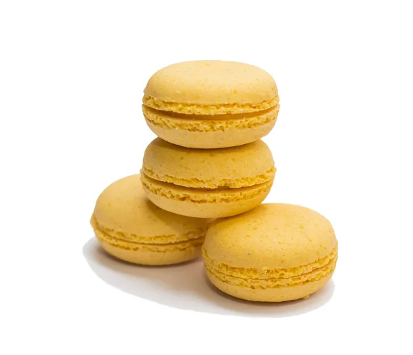 Four yellow macaroons on a white background isolated — Stock Photo, Image