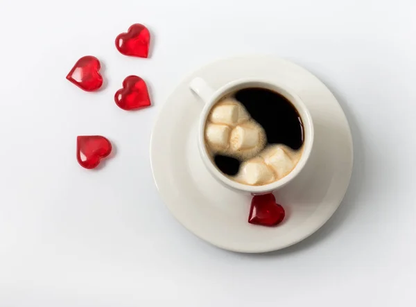 Cup with coffee and marshmallows and hearts as a symbol of love on Valentine\'s day.