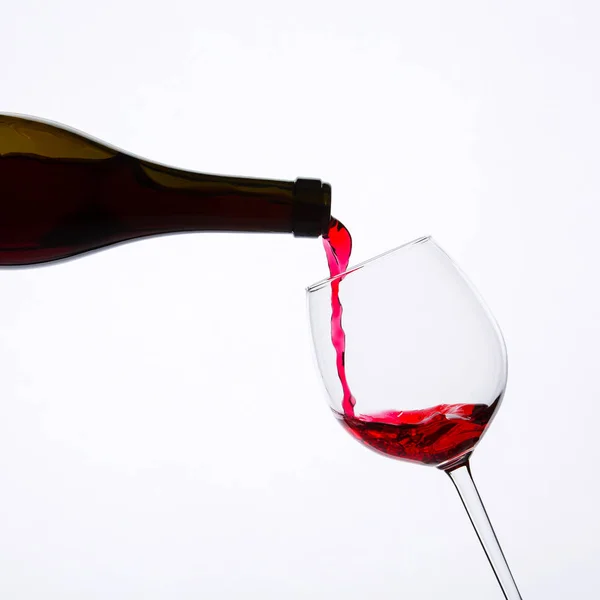 Red wine pouring in glass Stock Image