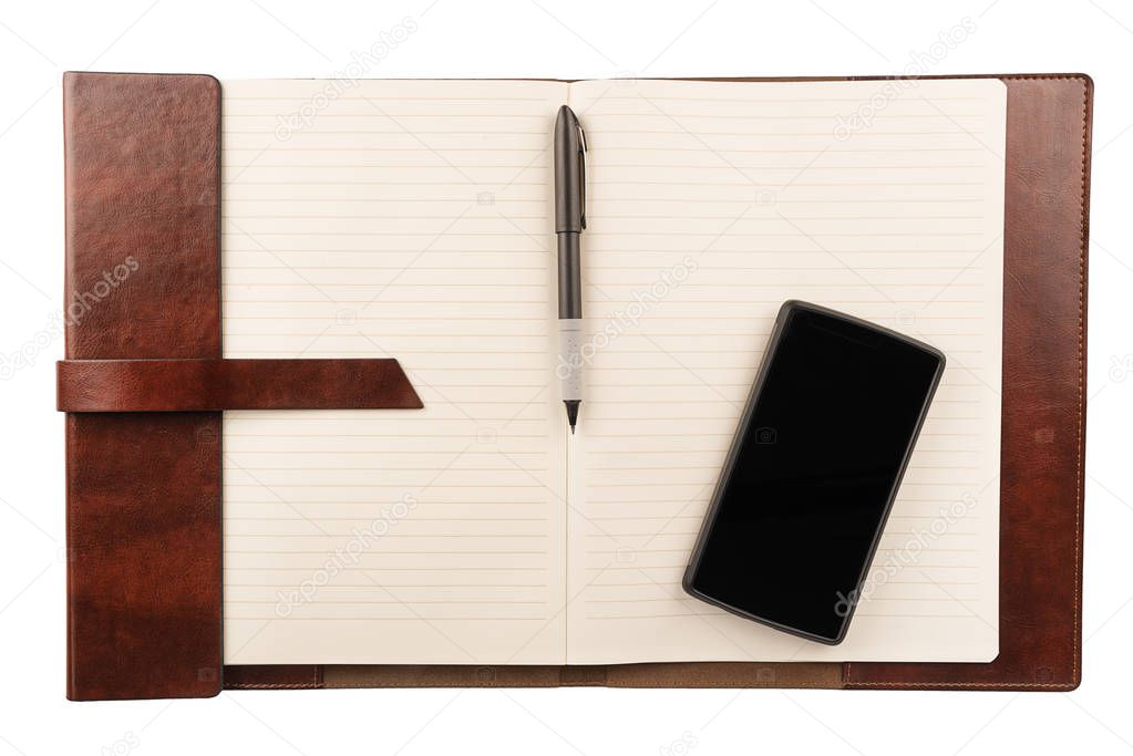 Pen and smartphone on an opened lined notepad, top view. Education or business concept.