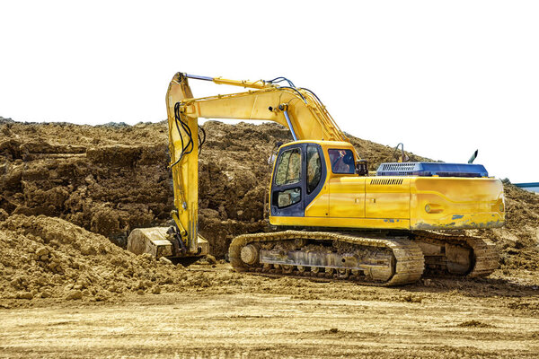 Excavating machinery at a construction site, isolated on a white background. Copy space for your text or your image.