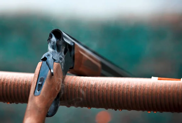 Hunting shotgun with bullets cartridges drop rain. smoke — Stock Photo, Image