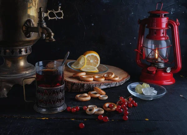 Tea from samovar, a Glass in glass holder, lemon, lantern . — Stock Photo, Image