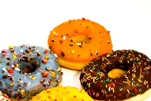 Sweet tasty donuts with colorful sprinkles isolated on white bac — Stock Photo, Image